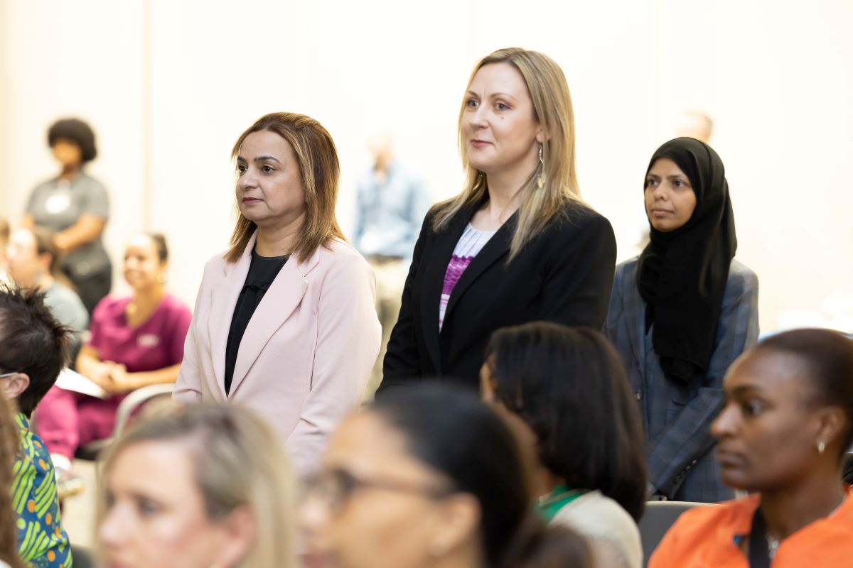 Preventive Medicine Residents standing Dr. Mann giving Preventive Medicine remarks at the 2023 Honors and Awards Ceremony